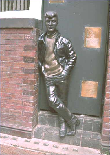 The John Lennon statue on Mathew Street in Liverpool, England. It stands across the street from the famous (although rebuilt) Cavern Club.