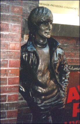 The John Lennon statue on Mathew Street in Liverpool, England. In this photo, the late rock star's is hair is longer and combed down in the traditional Beatle style.