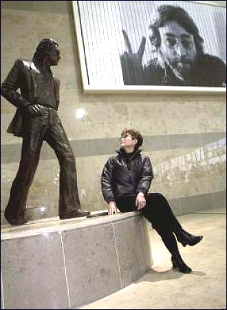 Yoko Ono admires the John Lennon statue at the John Lennon Liverpool Airport.