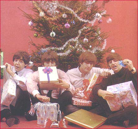 Beatles Around the Christmas Tree: In a 1965 photo session the Fab Four pose with gifts in front of a Christmas tree.