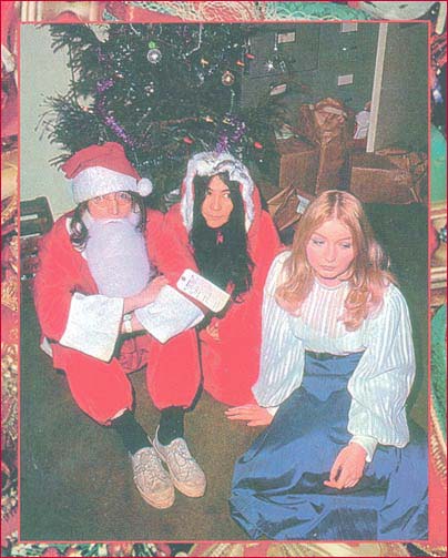 John and Yoko play Mr. and Mrs. Santa Claus at a party at Apple Records in the late 60s. Pictured right is singer Mary Hopkin.