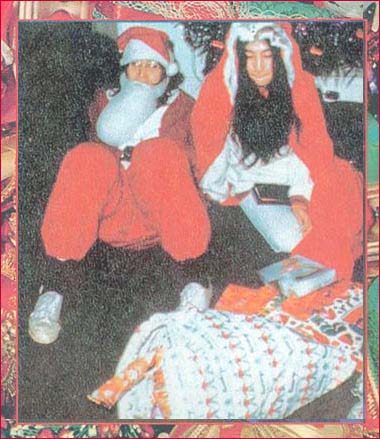 John and Yoko play Mr. and Mrs. Santa Claus at an Apply Christmas party in the late sixties.